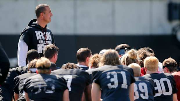 Luke Fickell speaking with his Cincinnati team during fall camp.
